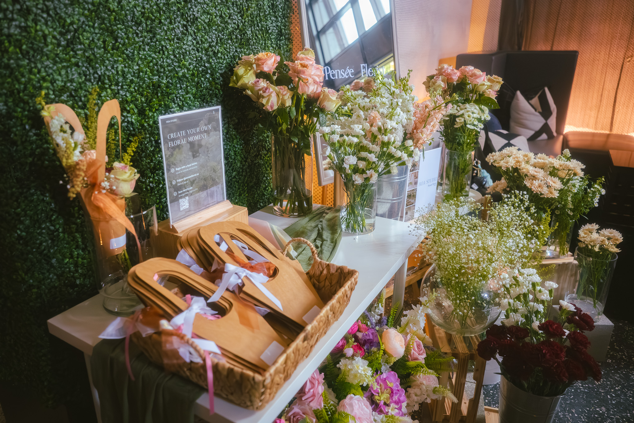 Full floral bar setup with stem buckets and wrapping